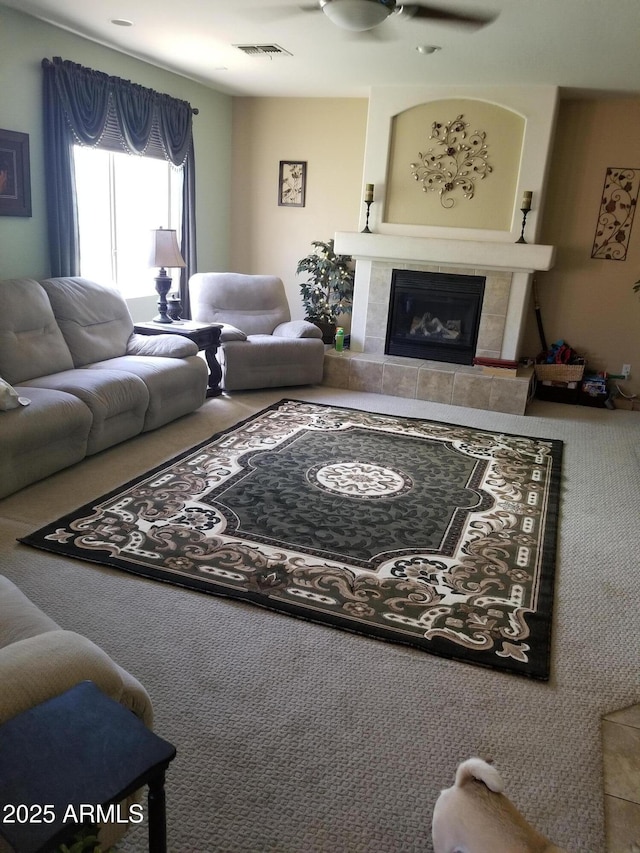 living room with a fireplace and ceiling fan