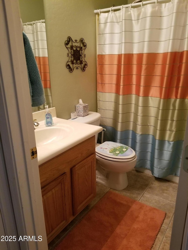 bathroom featuring tile patterned floors, vanity, and toilet