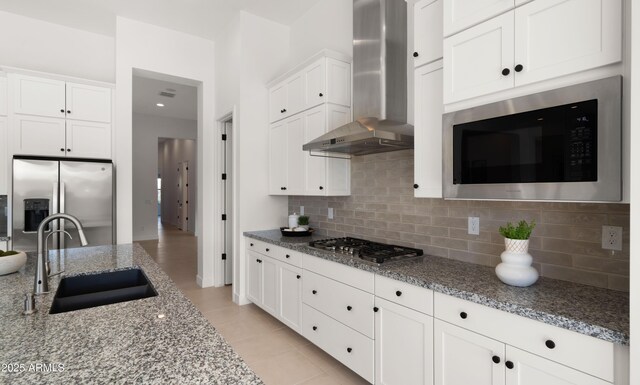 27908 N 38th Dr, Phoenix, AZ 85083 - kitchen with white cabinets, light stone counters, stainless steel appliances, wall chimney range hood, and a sink