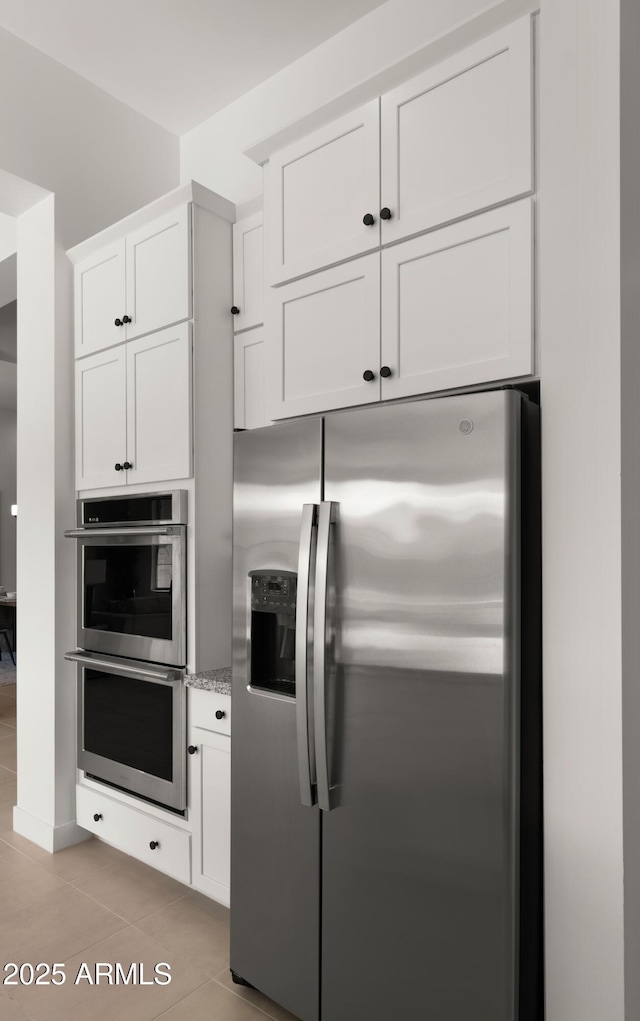 27908 N 38th Dr, Phoenix, AZ 85083 - kitchen featuring light tile patterned floors, light stone counters, white cabinetry, and appliances with stainless steel finishes