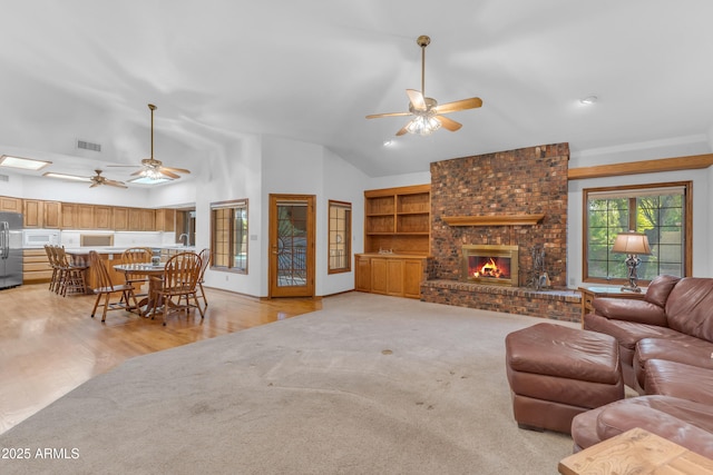 8604 S Oak St, Tempe, AZ 85284 - living area with ceiling fan, lofted ceiling, a fireplace, and light wood-style floors