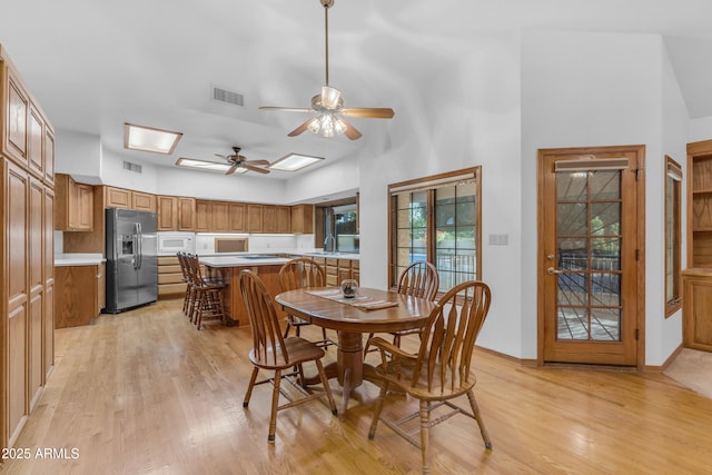 8604 S Oak St, Tempe, AZ 85284 - dining area featuring light wood-style floors, ceiling fan, and a high ceiling
