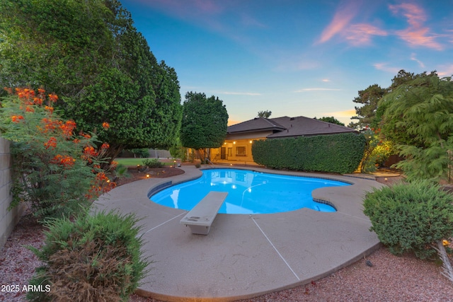 8604 S Oak St, Tempe, AZ 85284 - pool at dusk with a diving board, a fenced backyard, and a patio
