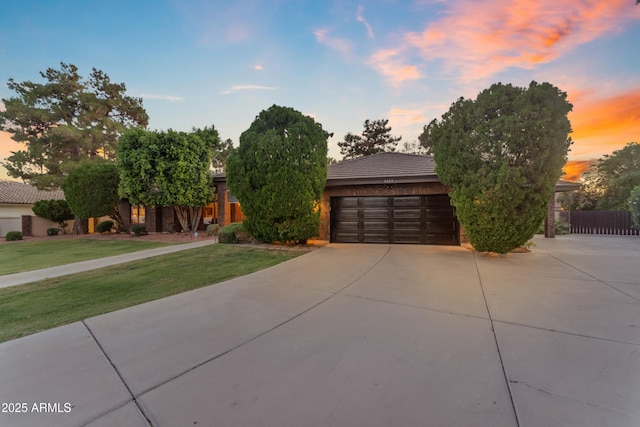 8604 S Oak St, Tempe, AZ 85284 - obstructed view of property with driveway, an attached garage, and a front lawn