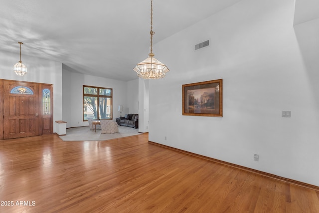 8604 S Oak St, Tempe, AZ 85284 - entryway featuring a chandelier, wood finished floors, and a towering ceiling