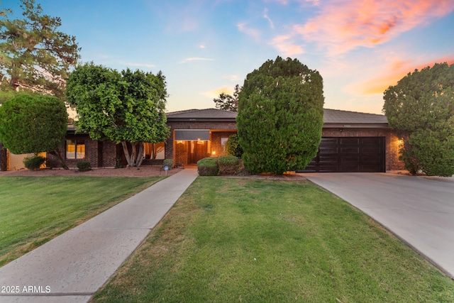 8604 S Oak St, Tempe, AZ 85284 - obstructed view of property with a garage, driveway, a front lawn, and brick siding