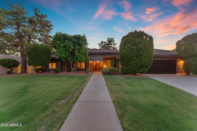 8604 S Oak St, Tempe, AZ 85284 - view of front of home with an attached garage, concrete driveway, and brick siding