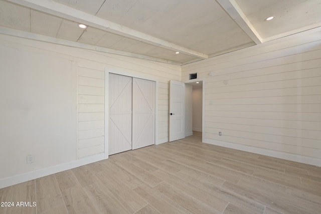 6312 N 13th St, Phoenix, AZ 85014 - unfurnished bedroom featuring light wood-style floors, wood walls, baseboards, and wood ceiling with exposed beams