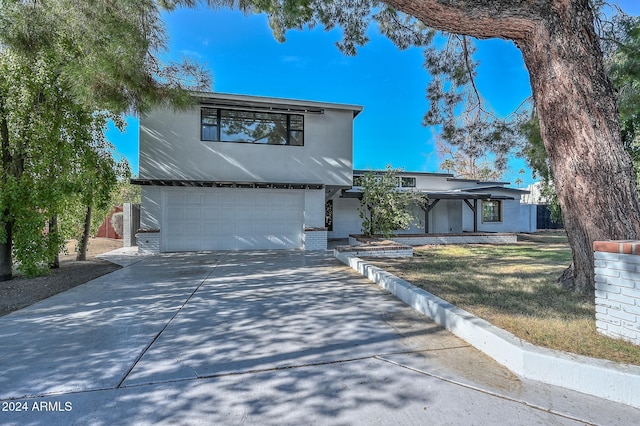 6312 N 13th St, Phoenix, AZ 85014 - mid-century home with an attached garage, driveway, brick siding, and a front yard