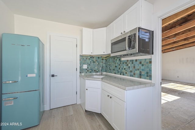 6312 N 13th St, Phoenix, AZ 85014 - kitchen with fridge, a sink, stainless steel microwave, light countertops, and decorative backsplash