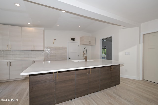 6312 N 13th St, Phoenix, AZ 85014 - kitchen with modern cabinets, a sink, light countertops, decorative backsplash, and a large island