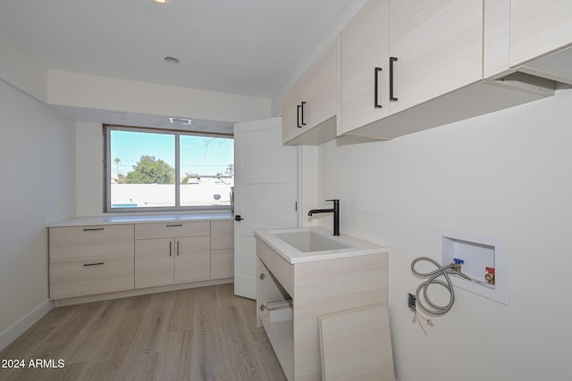 6312 N 13th St, Phoenix, AZ 85014 - laundry room featuring cabinet space, washer hookup, and light wood-type flooring