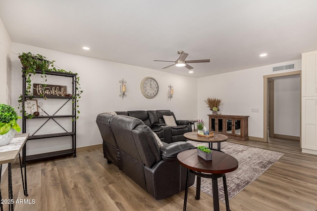 living room featuring hardwood / wood-style flooring and ceiling fan