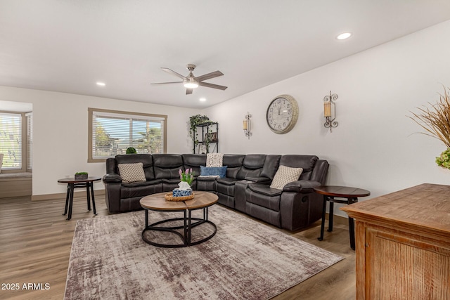 living room featuring ceiling fan, hardwood / wood-style floors, and plenty of natural light