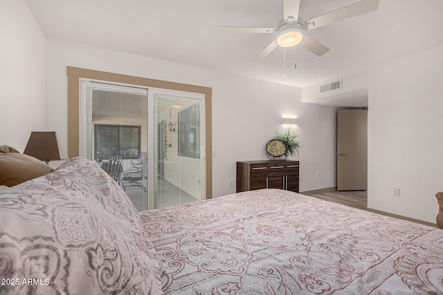 bedroom featuring light hardwood / wood-style floors, ceiling fan, and access to outside