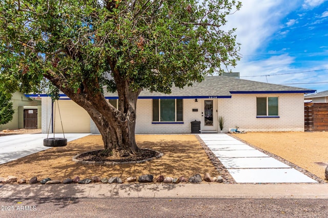 3038 E Avalon Dr, Phoenix, AZ 85016 - view of front of home with brick siding, concrete driveway, and roof with shingles