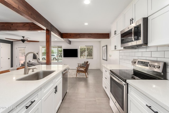 3038 E Avalon Dr, Phoenix, AZ 85016 - kitchen featuring appliances with stainless steel finishes, a sink, recessed lighting, decorative backsplash, and light countertops