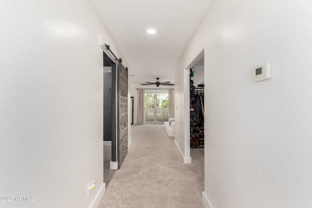 3038 E Avalon Dr, Phoenix, AZ 85016 - hallway featuring a barn door, light carpet, baseboards, and recessed lighting
