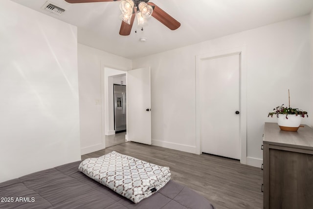 3038 E Avalon Dr, Phoenix, AZ 85016 - bedroom with stainless steel refrigerator with ice dispenser, wood finished floors, baseboards, and a ceiling fan