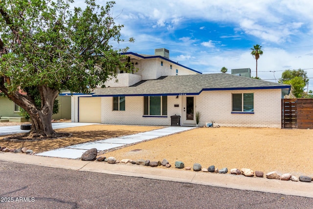 3038 E Avalon Dr, Phoenix, AZ 85016 - view of front of house with brick siding, concrete driveway, an attached garage, and roof with shingles