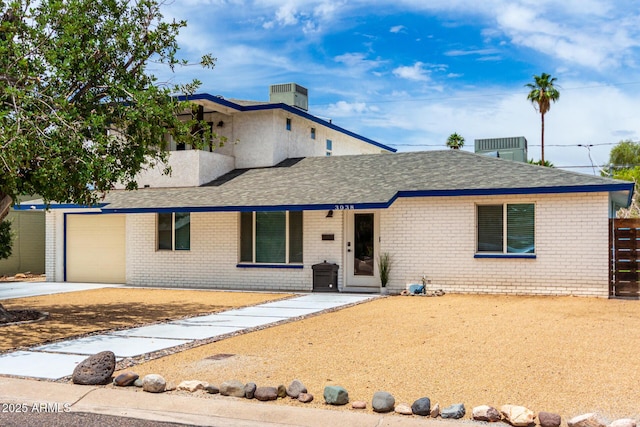 3038 E Avalon Dr, Phoenix, AZ 85016 - view of front of house with brick siding, driveway, an attached garage, and a shingled roof