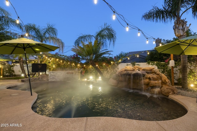 view of pool at dusk