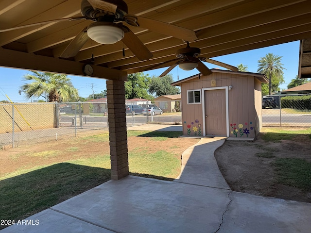 view of yard with ceiling fan and a shed