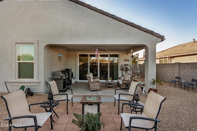 view of patio with ceiling fan and a grill