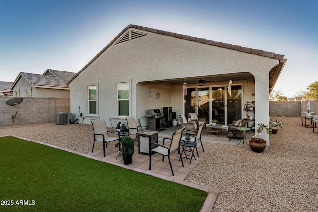 rear view of property featuring ceiling fan, central AC, and a patio