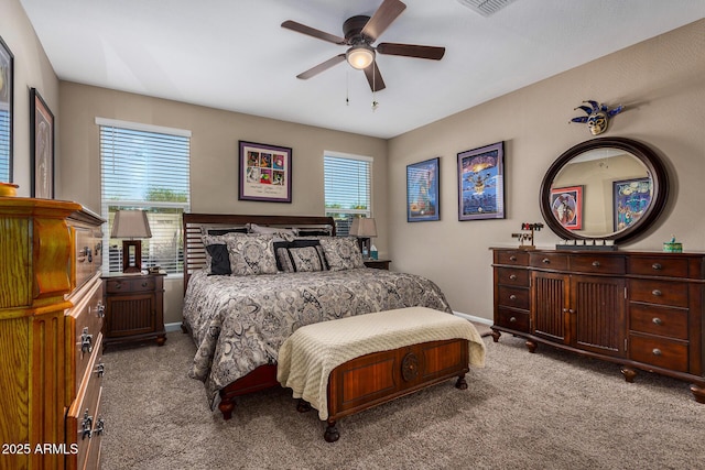 carpeted bedroom with ceiling fan and multiple windows