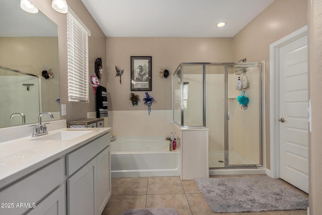 bathroom with shower with separate bathtub, vanity, and tile patterned flooring