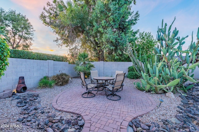 view of patio terrace at dusk