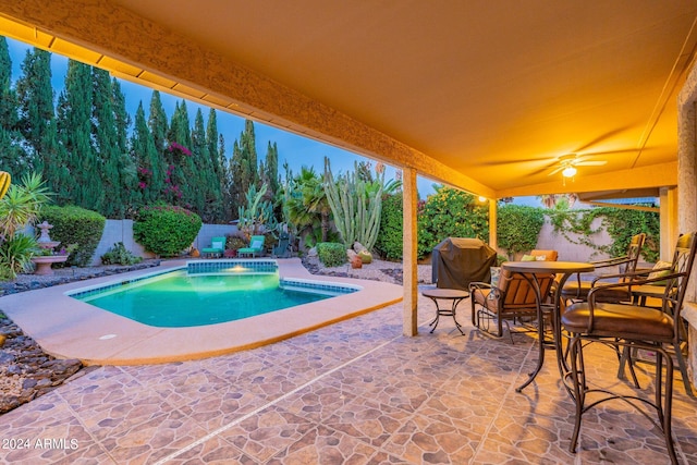 view of pool featuring ceiling fan, a patio, and a hot tub