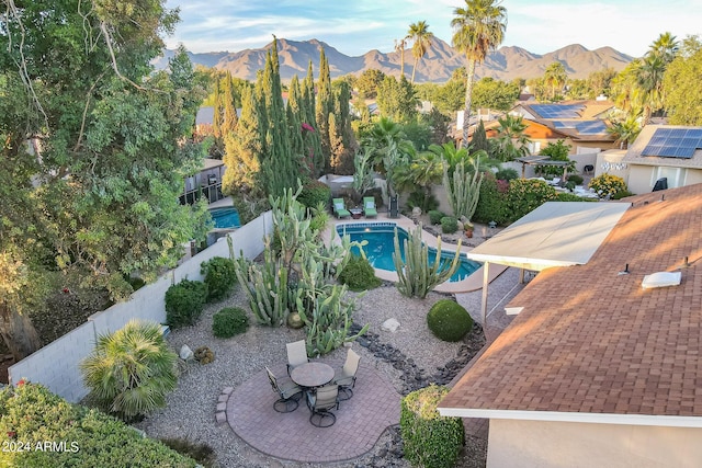 view of pool with a mountain view and a patio