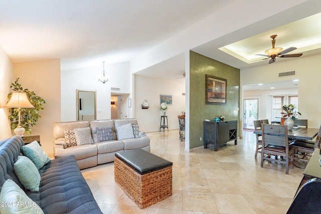 tiled living room featuring ceiling fan and vaulted ceiling