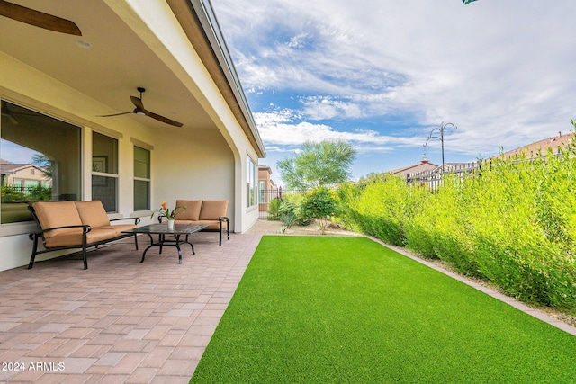 view of yard featuring a patio and ceiling fan