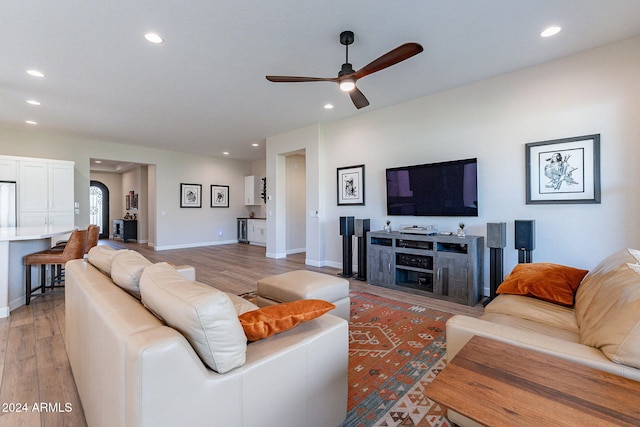 living room featuring ceiling fan and hardwood / wood-style floors