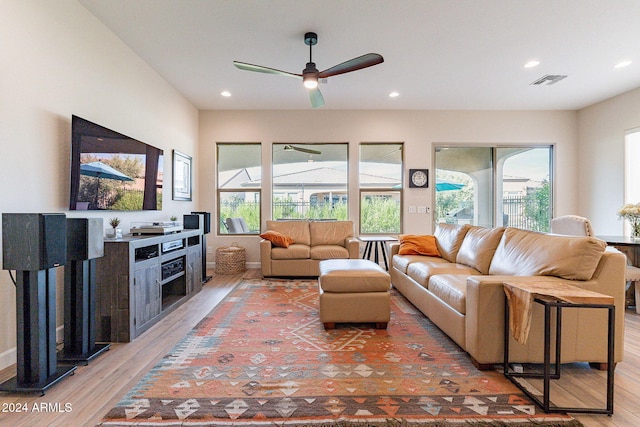 living room featuring wood-type flooring and ceiling fan