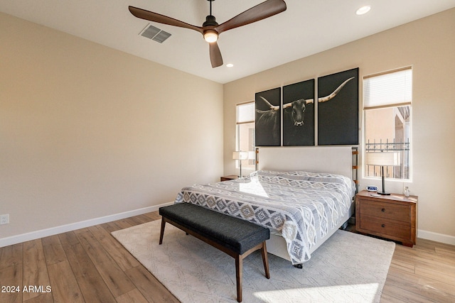 bedroom with ceiling fan and light hardwood / wood-style flooring