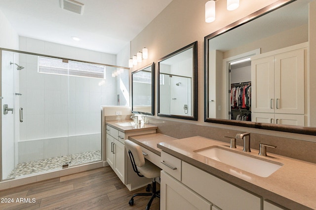 bathroom featuring vanity, a shower with shower door, and hardwood / wood-style flooring