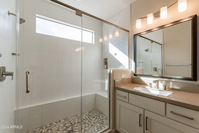 bathroom featuring vanity and an enclosed shower