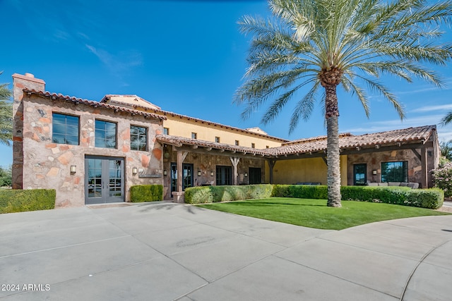 mediterranean / spanish house featuring a front yard