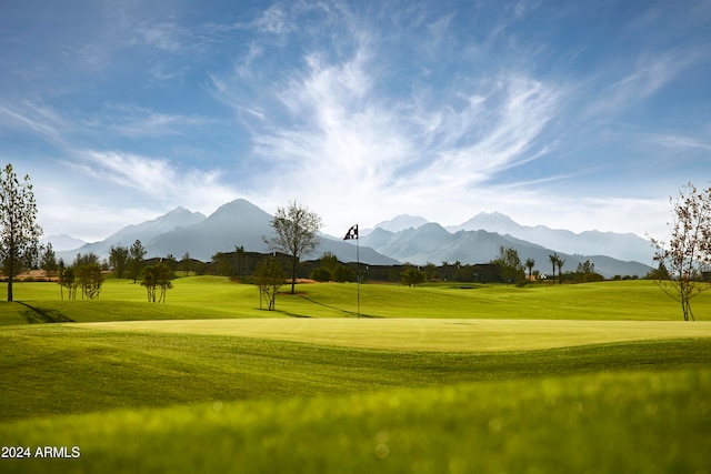 view of community featuring a mountain view and a lawn