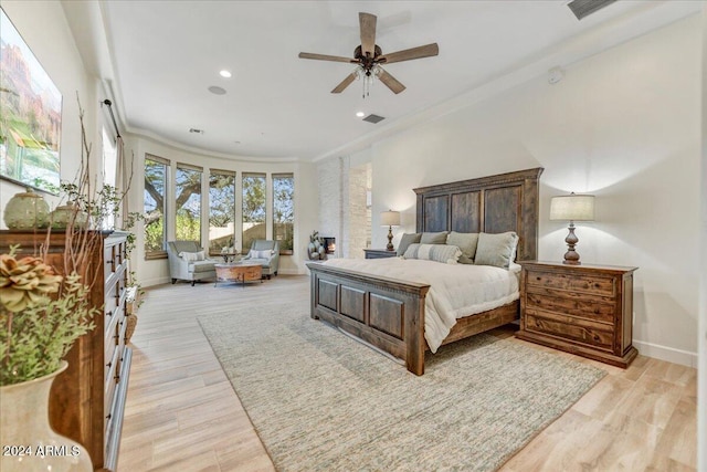 bedroom featuring ceiling fan, crown molding, and light wood-type flooring