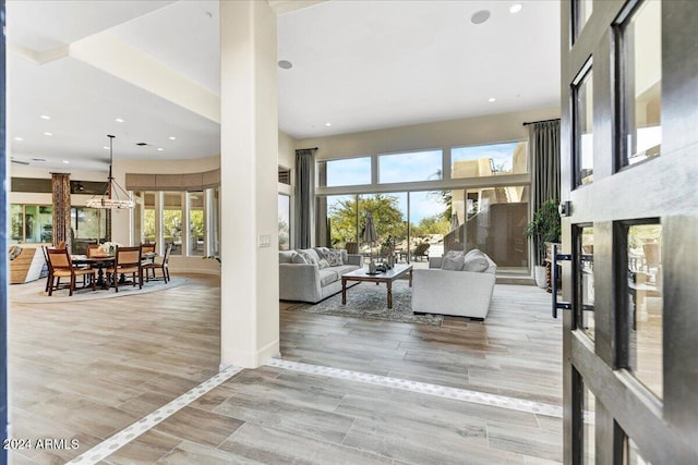 living room featuring light wood-type flooring and a healthy amount of sunlight