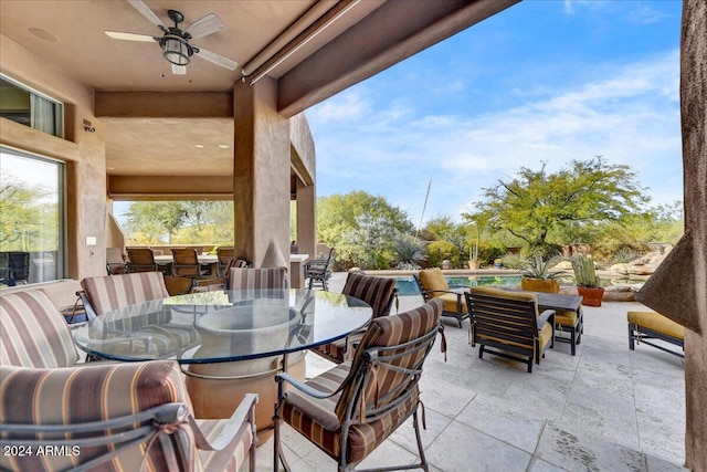 view of patio with ceiling fan and a swimming pool