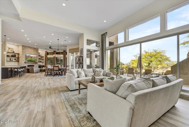 living room with light hardwood / wood-style floors and a high ceiling