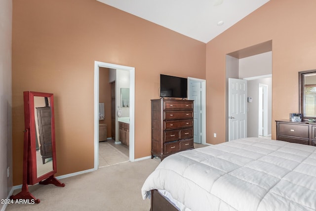 carpeted bedroom with ensuite bath and high vaulted ceiling