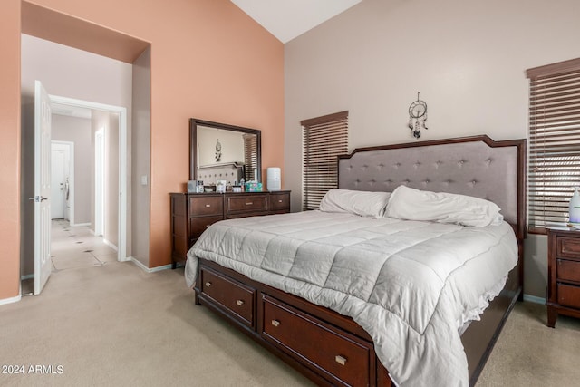 carpeted bedroom featuring lofted ceiling