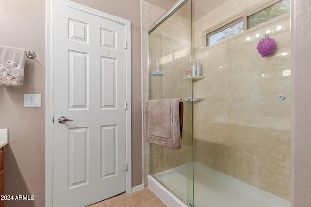 bathroom featuring tile patterned flooring, vanity, and an enclosed shower